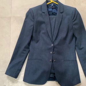 Worn only twice, this classic pantsuit was purchased for a professional attorney